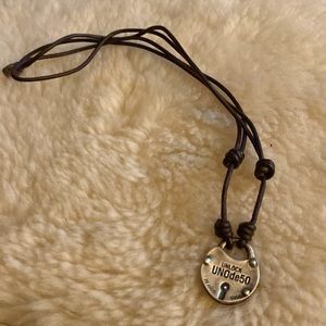 Padlock is silver on brown leather cord